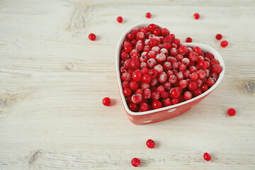 frozen red currants on wooden surface