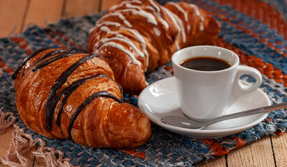 Excellent breakfast: a cup of espresso coffee and a croissant