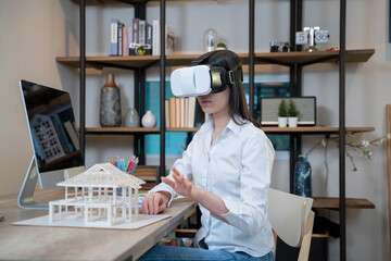 Women with architectural model and VR glasses.