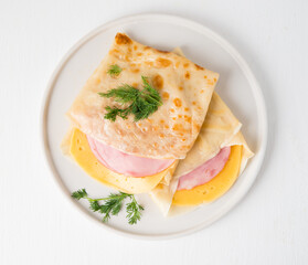 Homemade pancakes with ham and cheese on a white background, Maslenitsa