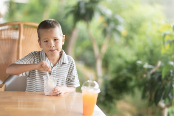 Boy eating ice-cream in outdoor cafe