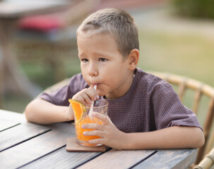 Boy eating ice-cream in outdoor cafe