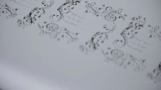 Close-up view. Automatic line for printing on paper. Stamping, foil and glitter. Relief. Concept for printing, industrial production of cardboard packaging and printing.