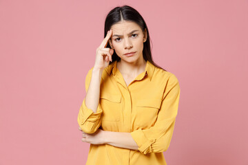 Young brunette thoughtful pensive overthinking latin student woman 20s wearing yellow casual shirt...