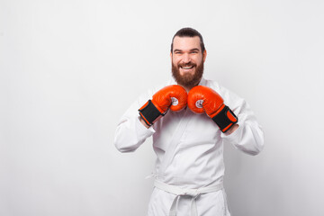 Portrait of smiling taekwondo fighter wearing red boxing gloves.