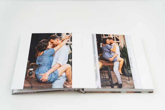 pages of photobook from photo shoots of a beautiful happy couple 
