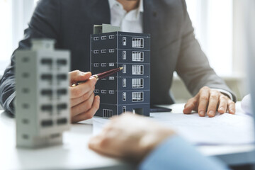 real estate developer and architect discussing new housing development project in office