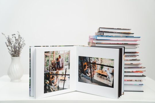 stack of books. open photobook from photo shoots of a beautiful happy couple 