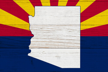 Arizona state flag with the state map over weathered wood