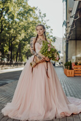 Fototapeta premium Portrait of a happy beautiful long-haired bride with two braids.