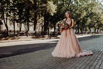 Fototapeta premium Portrait of a happy beautiful long-haired bride with two braids.