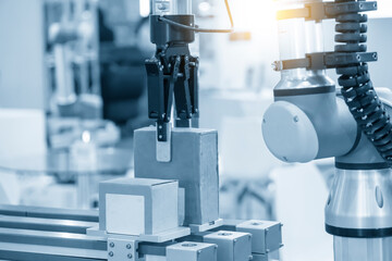 The hi-technology  material handling process by robotic system. The automatic pneumatic robotic arm picking the container box in production line.