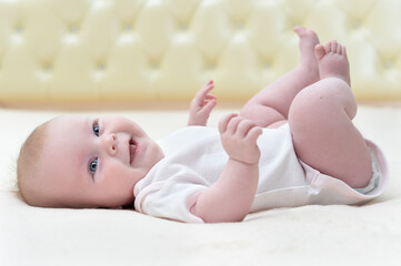 cute newborn baby girl lying on her back