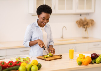 Black Woman Cooking Salad Cutting Vegetables Standing In Kitchen Indoors