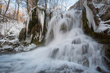 Fototapeta na wymiar Frozen beautiful waterfall, Beusnita National Park, Romania