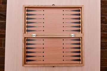 Backgammon game. Backgammon board on a wooden background