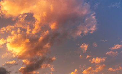 Natural sky background. Bright sunset with orange clouds.