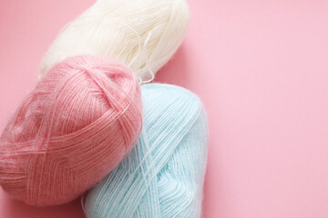 pastel colours yarn balls on pink background