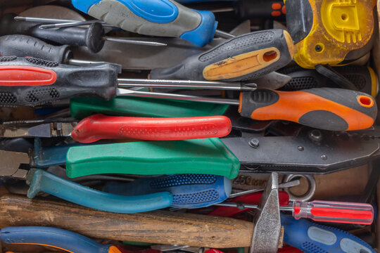 A set of multicolored hand tools. Colored background