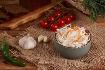 White sauerkraut in a bowl on a wooden background