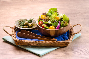 Healthy organic fresh vegetable salad, fresh leaves mix salad in wooden bowl on wooden table Healthy and Diet food.