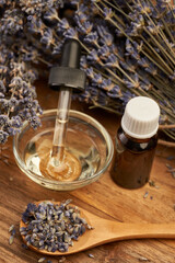 Obraz na płótnie Canvas Lavender essential oil and dried flowers