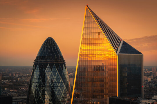 View at  London's landmark buildings during sunset from Sky Garden Terraces. Tips of The Gherkin and The Scalpel. Both commercial skyscrapers in London, City of London. United Kingdom.