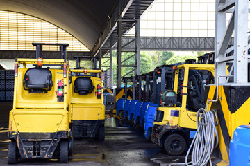 Forklift trucks parked in a warehouse.