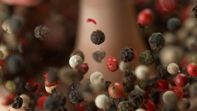 Crushing Colorful Peppercorns in Olive Wood Mortar with Pestle in Macro and Slow Motion (Phantom Flex)
