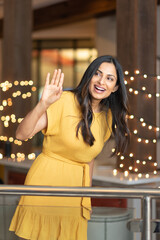 Beautiful Asian Indian woman waving.