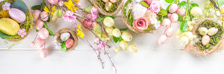 Fototapeta na wymiar Happy easter background with Nests decoration, colorful eggs and Spring Flowers. Caster card on sunny spring background