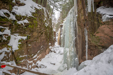 Fototapeta na wymiar An icy and impassible Flume Gorge in Franconia Notch, NH