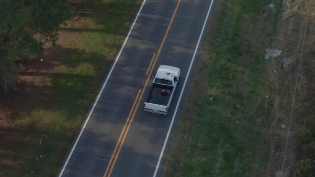 Aerial Overhead of Truck Driving On Lone Road