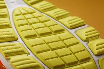 Textured design of the sole of the Tread of a sneaker in yellow Macro.