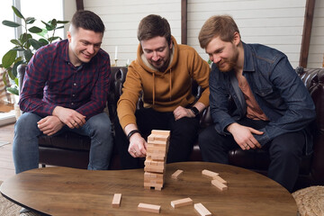The company of guys plays board games, teamwork