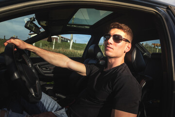 Young caucasian adult inside a sports car