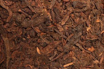 Puer tea dry texture. Health drink pressed brown tea macro background.