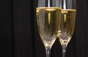 Champagne glasses on a dark background. The concept of the celebration.