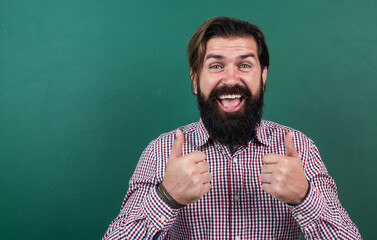 happy bearded mature hipster showing thumb up, success