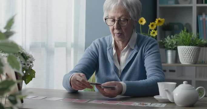 Senior woman playing solitaire