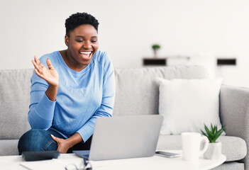 Black woman having video call using computer and gesturing