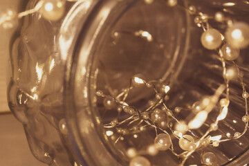 Vintage photography. Thin garland with pearls in a jar