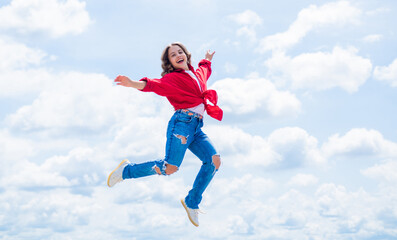 Fototapeta na wymiar free your imagination. kid beauty and fashion. child jump in casual style. Child jumping on background of sky. summer holiday concept. childhood happiness. happy childrens day