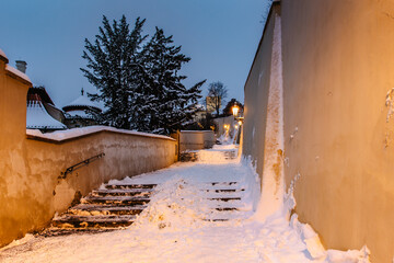 Old Castle Stairs at night, Prague, Czech Republic.Beautiful spectacular winter panorama of Vltava river and historical buildings.Romantic way up from Lesser Town to Prague Castle.Snowy cityscape