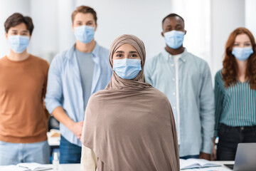 Diverse group of international people wearing medical protective face masks