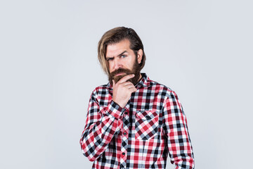 Fototapeta premium thinking about something. bearded man wear checkered shirt. confident and handsome brutal man. male barber care. hair and beard care. mature hipster with beard. brutal caucasian guy with moustache