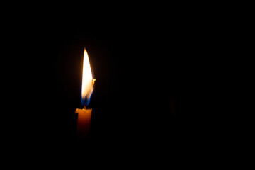 Burning candle isolated on black background with space for text. Concept of mourning, sadness,...