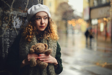 Portrait of a woman waiting for someone with teddy bear present