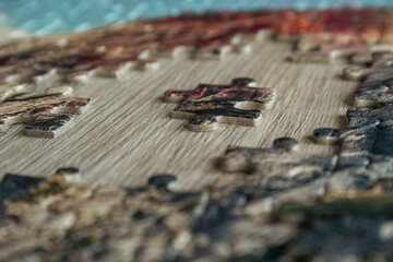 Jigsaw puzzle. Closeup of colorful jigsaw puzzle peices. Conceptual photo with focus on undone puzzle
