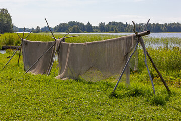 Fishihg nets dry on the bank of Onega lake on the Kizhi island, Karelia, Russia